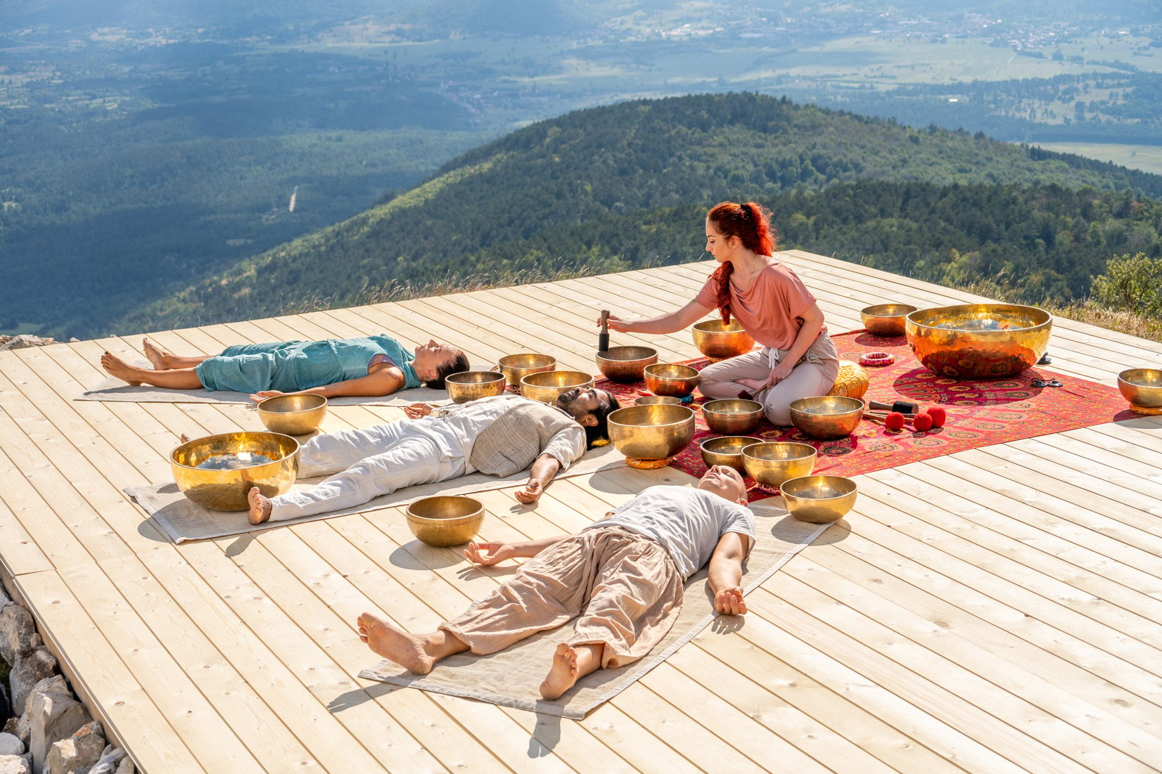 Singing bowls meditation, people group at sound healing therapy session